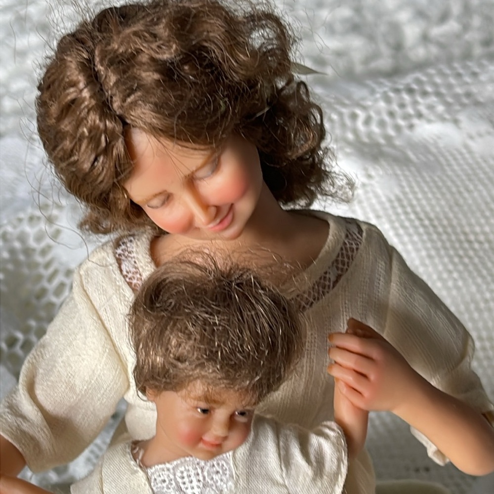 Vintage approx year 2000 Mother and child atop upholstered bench. So endearing.